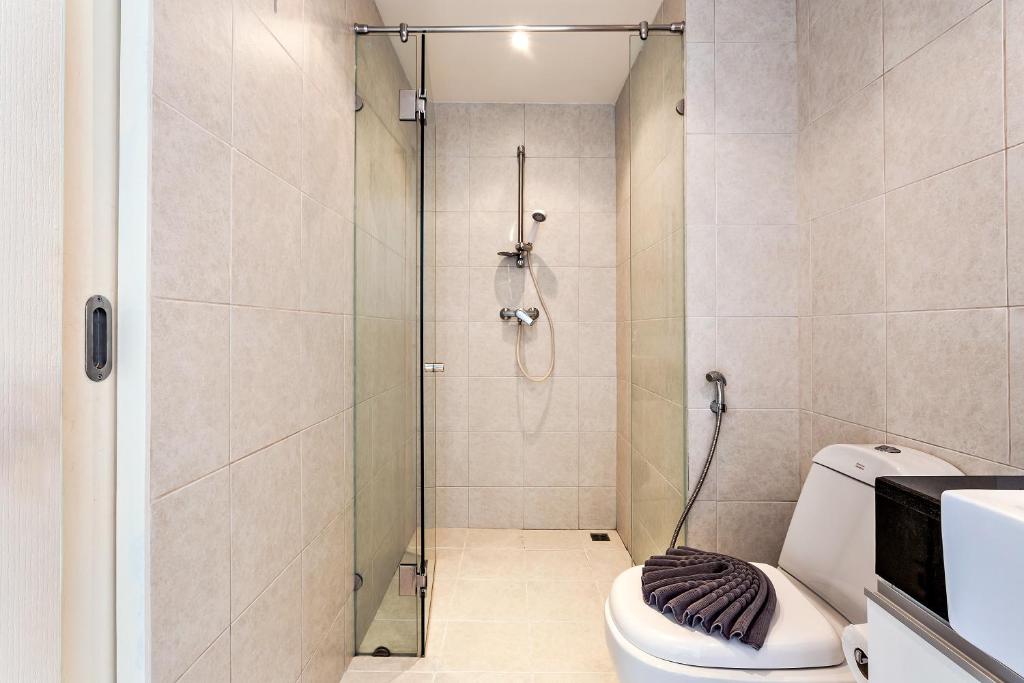 a bathroom with a shower and a toilet at Kata Ocean View condominium by Lofty in Kata Beach