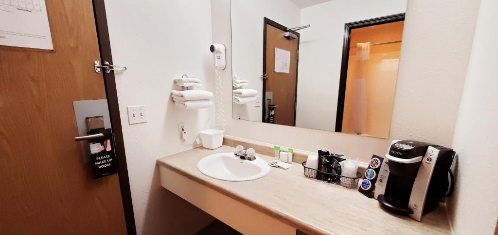a bathroom with a sink and a mirror at Westlake Inn in Strathmore
