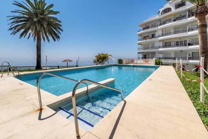 een zwembad voor een groot gebouw bij Perfect Family Apartment in Acapulco Playa, Nerja in Nerja