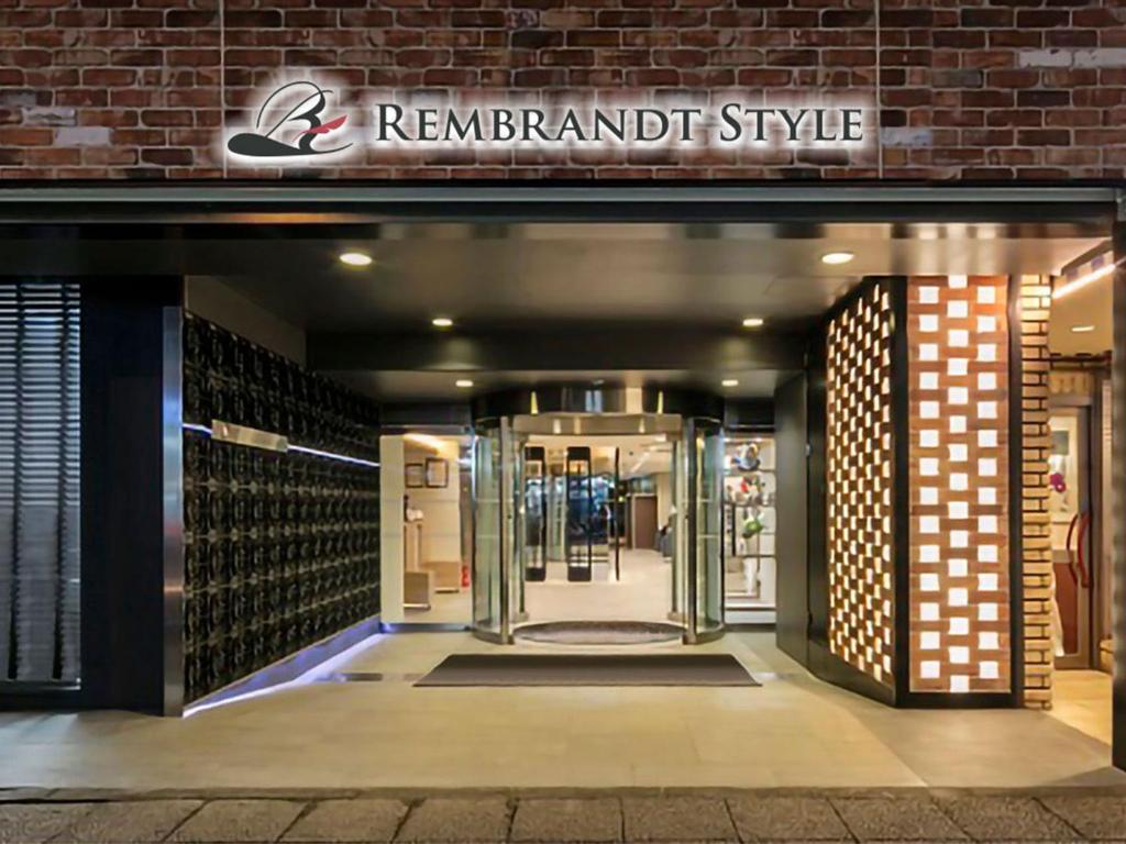 a store entrance with a revolving door in a brick building at Rembrandt Style Yokohama Kannai in Yokohama