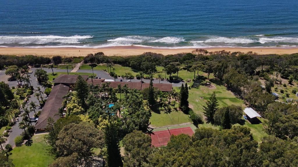 an aerial view of a park next to the ocean at Diamond Beach Resort, Mid North Coast NSW in Diamond Beach