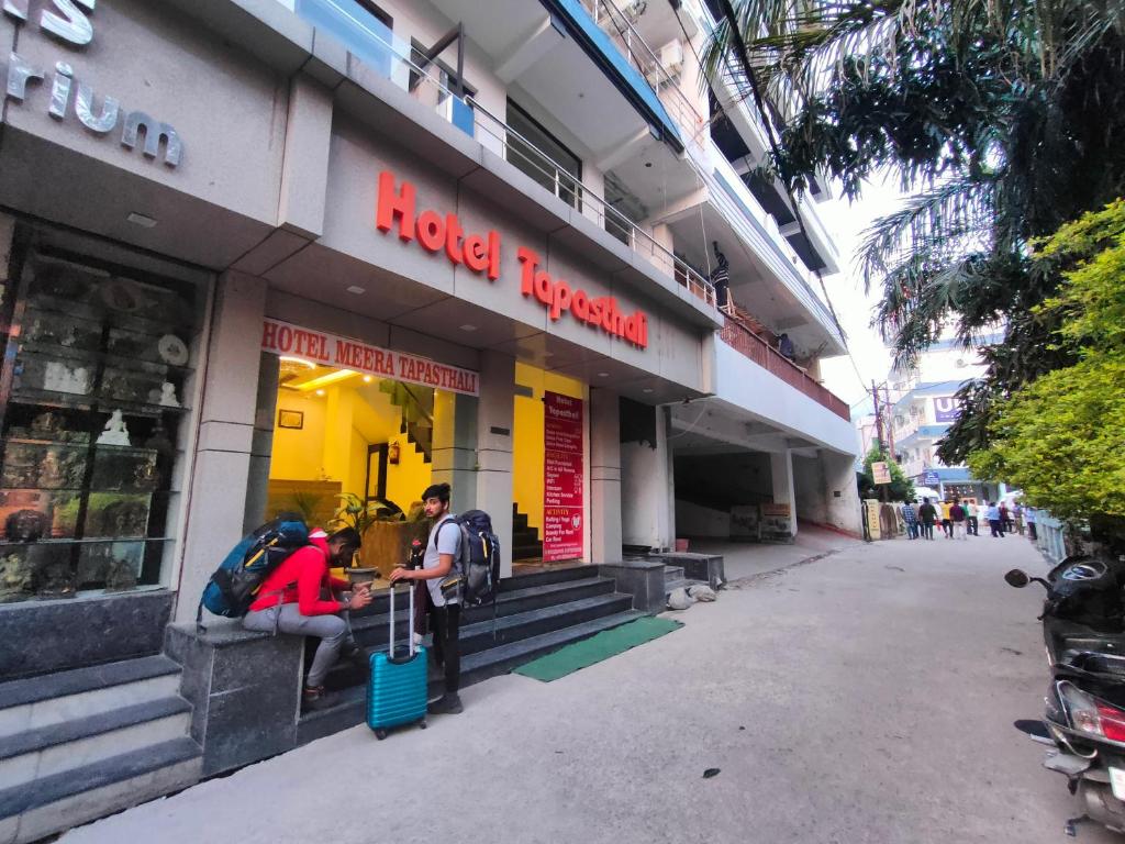 a man and woman standing outside of a store at Tapasthali by Meera Hotels in Rishīkesh