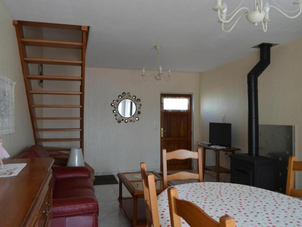 a living room with a table and chairs and a staircase at Gîte Valençay, 4 pièces, 6 personnes - FR-1-591-148 in Valençay