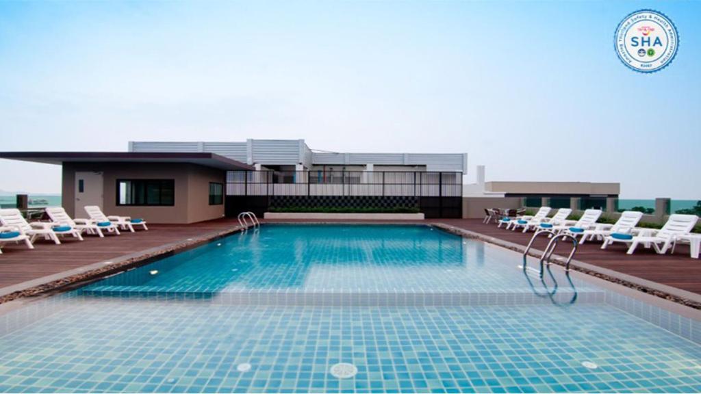 a swimming pool on the roof of a building at The Stay Hotel "SHA Certified" in Pattaya