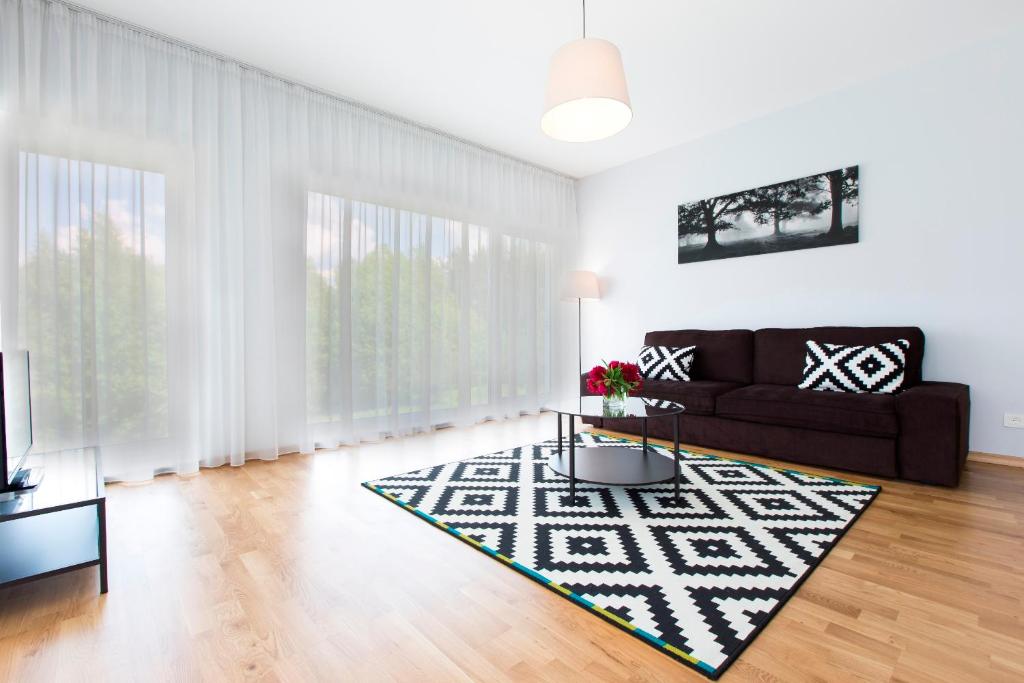 a living room with a couch and a rug at ForRest Apartments in Vilnius