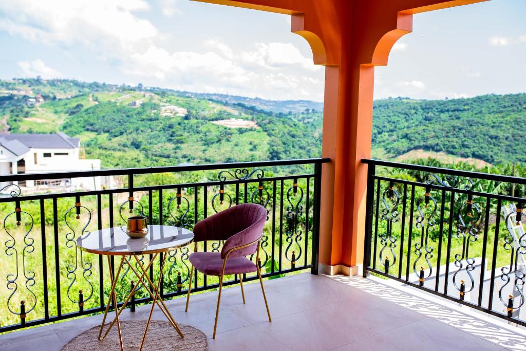 een balkon met een tafel en stoelen en uitzicht bij Piano & Gold Collections, Peduase in Peduasi
