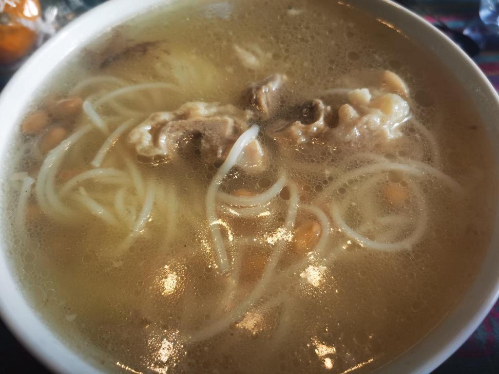 a bowl of soup with noodles and other ingredients at Shenzhen Xichong beach Lanting Homestay in Dapengcheng