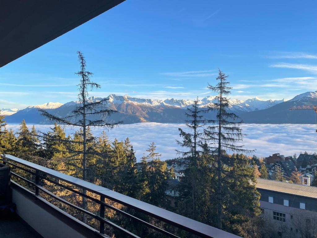 a view of the mountains from the balcony of a building at Sorecrans in Crans-Montana