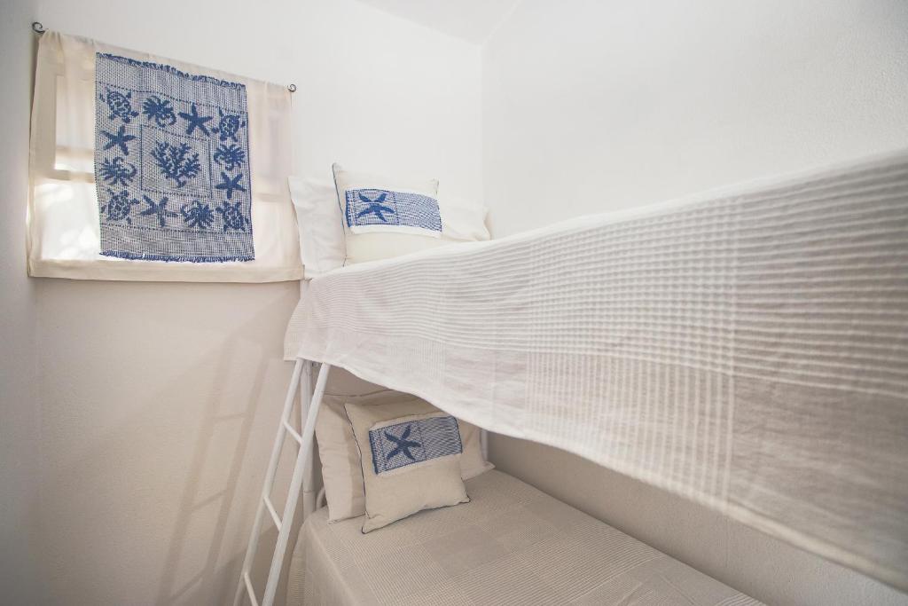 Postel nebo postele na pokoji v ubytování Village & Camping La Foce