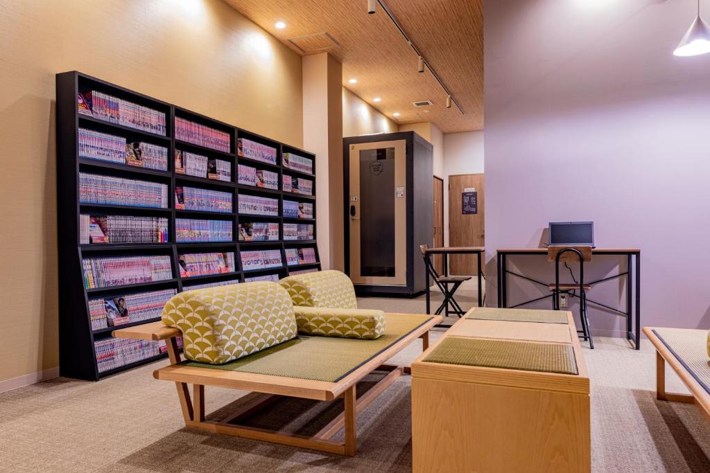 a waiting room at a pharmacy with a couch and tables at bnb+ Tsuruhashi in Osaka