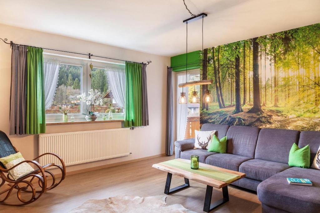 a living room with a couch and a table at Ferienwohnung Waldruhe in Garmisch-Partenkirchen