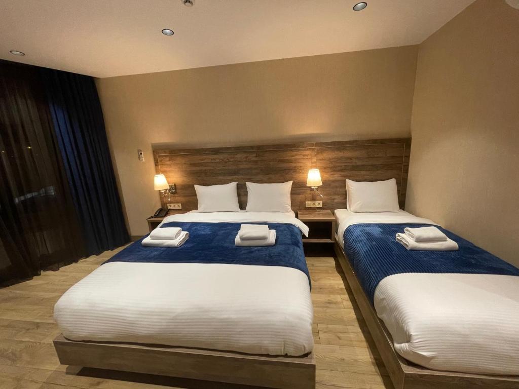 Postel nebo postele na pokoji v ubytování Cozy Loft Hotel