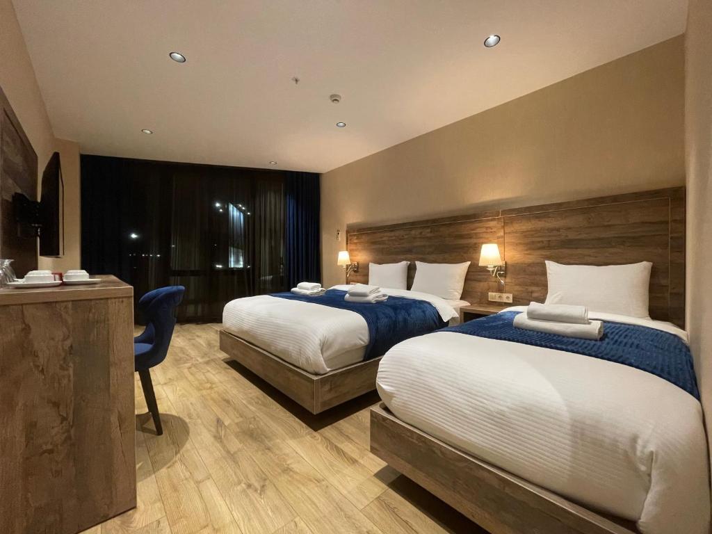 Postel nebo postele na pokoji v ubytování Cozy Loft Hotel