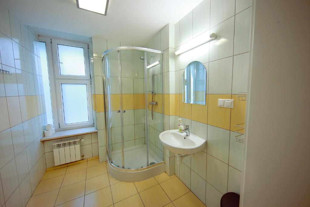 a bathroom with a shower and a sink at eMKa Hostel in Warsaw