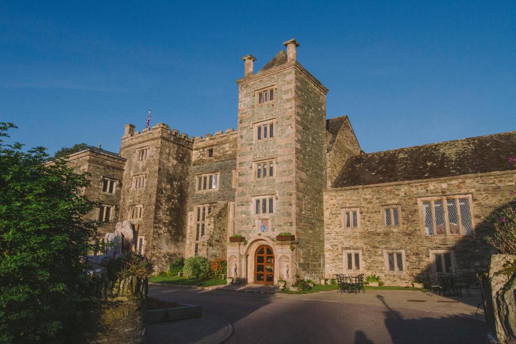 
a large stone building with a clock on the side of it at Boringdon Hall Hotel and Spa in Plymouth
