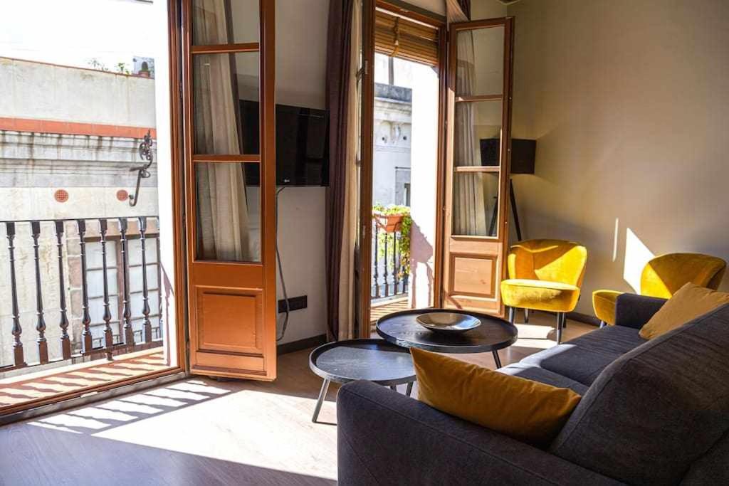 a living room with a couch and a table at Inspired Apartments Barcelona in Barcelona