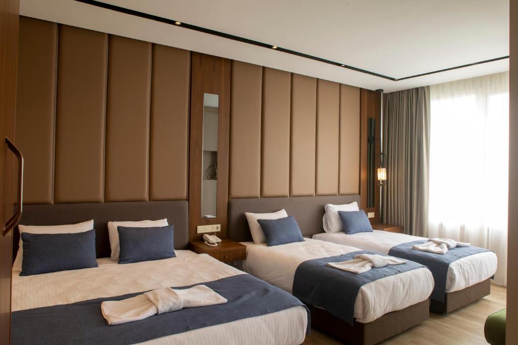 Postel nebo postele na pokoji v ubytování Martinenz Hotel
