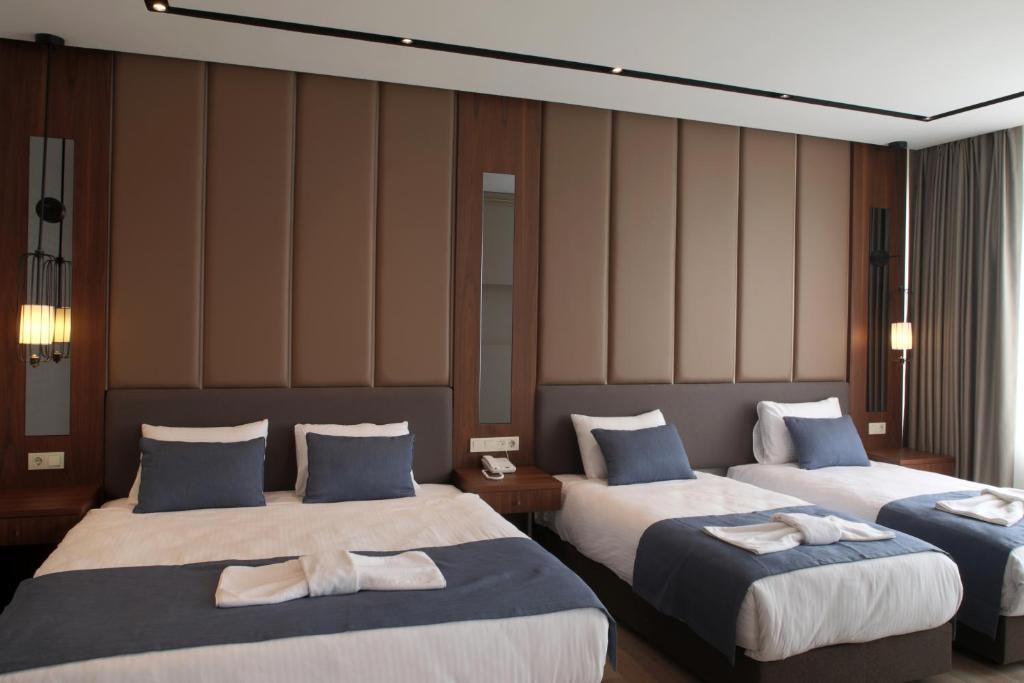 Postel nebo postele na pokoji v ubytování Martinenz Hotel
