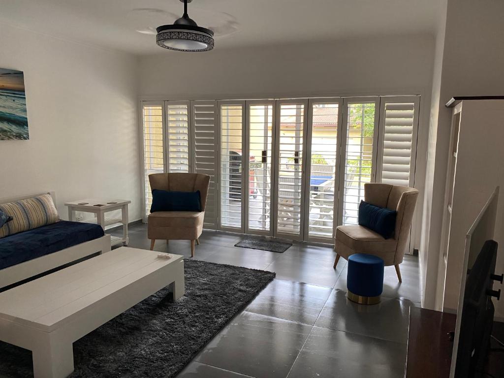 a living room with a couch and two chairs at Ballito Durban north Aloha in Ballito