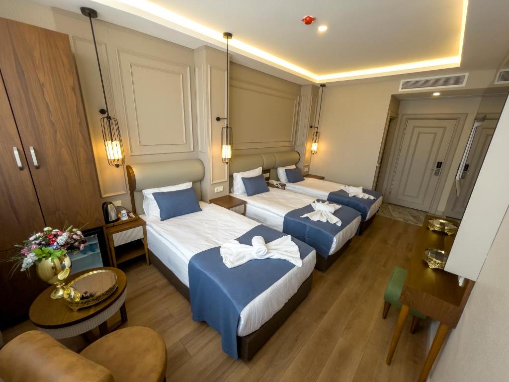 Postel nebo postele na pokoji v ubytování Martinenz Hotel