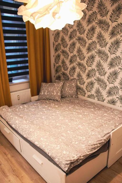 Posteľ alebo postele v izbe v ubytovaní Apartament Kattowitz