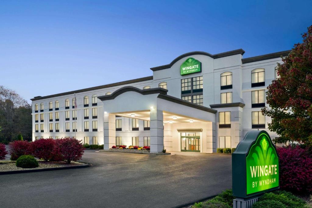 a hotel building with a sign in front of it at Wingate by Wyndham Bridgeport Clarksburg in Bridgeport
