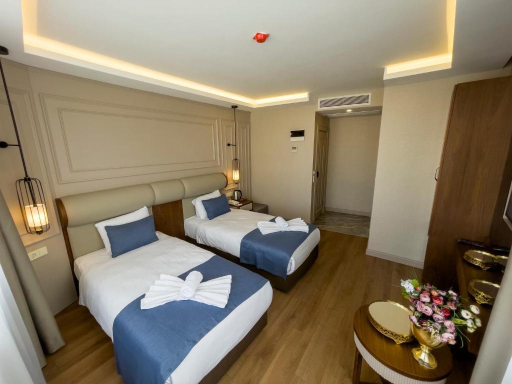 Postel nebo postele na pokoji v ubytování Martinenz Hotel