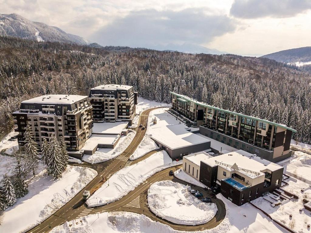 an aerial view of a resort in the snow at Twin studio Silver Mountain Poiana Brasov in Poiana Brasov