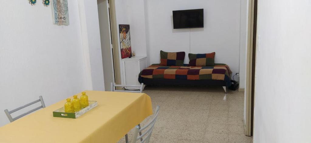 sala de estar con mesa amarilla y sofá en Cómodo dpto con Exlente ubicación en Mar del Plata