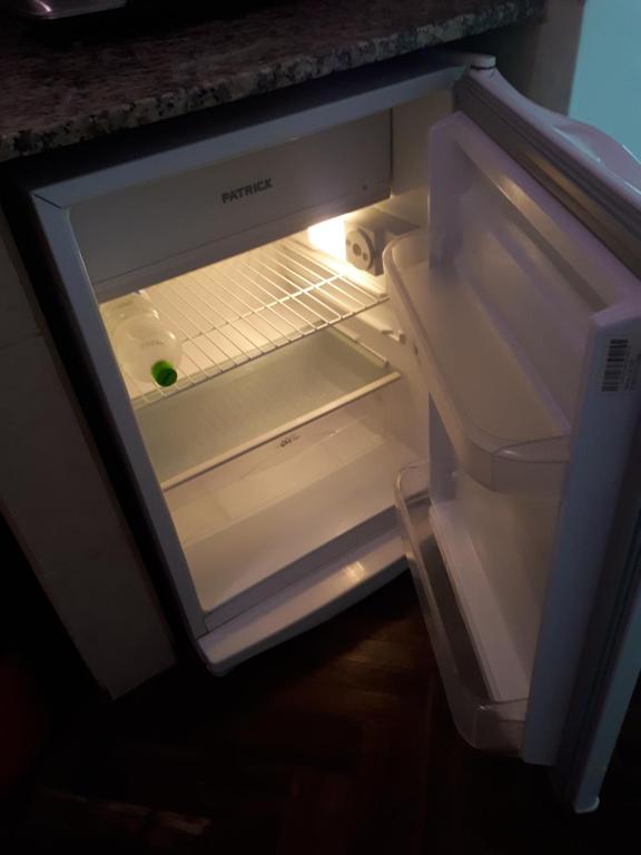 an empty refrigerator with a greengger inside of it at Apartment Salta 2 pax in Salta