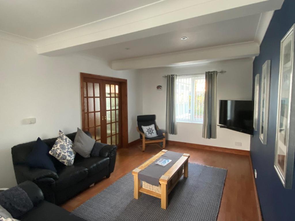 a living room with a couch and a coffee table at Craster Crew House in Craster