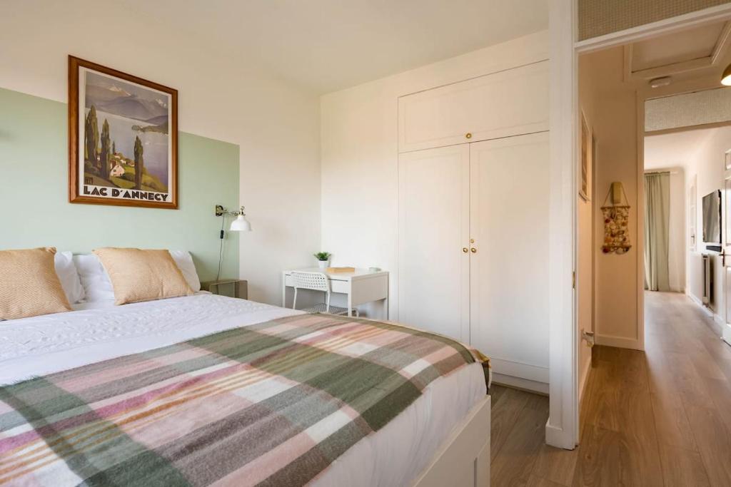 a bedroom with a bed with a striped blanket at Stylish apartment with balcony, minutes from beach in Redcar