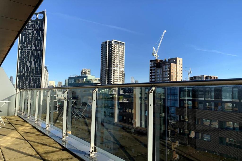 a view of a city from the balcony of a building at Stylish 2 Bedroom Apartment in London