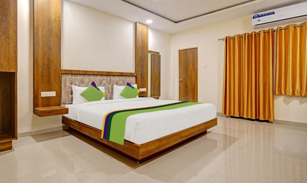 a bedroom with a large bed in a room at Treebo Trend Royal Empire Indore in Indore