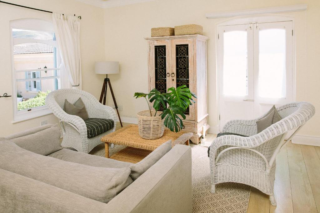 a living room with a couch and chairs and a table at Auberge Burgundy Boutique Hotel & Spa in Hermanus