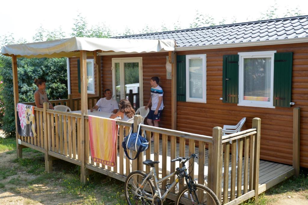 a group of people on the porch of a house at Camping Les Albères - Maeva in Laroque-des-Albères