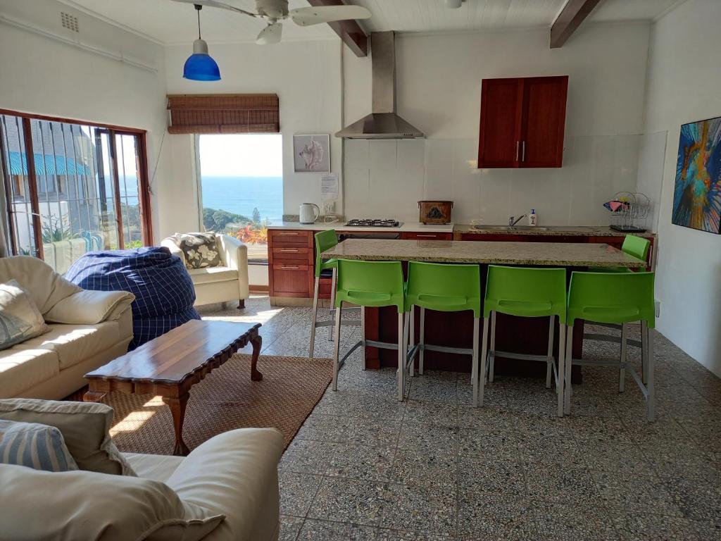 a kitchen with a table and chairs in a room at Ocean rush barracuda in Zinkwazi Beach