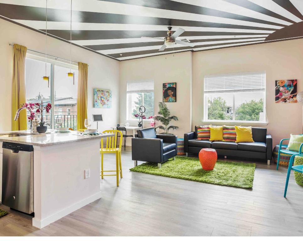 a living room with a kitchen and a living room with a table at Lux House Of Champagne 2BR 2BA Free Parking & Wifi in Baltimore