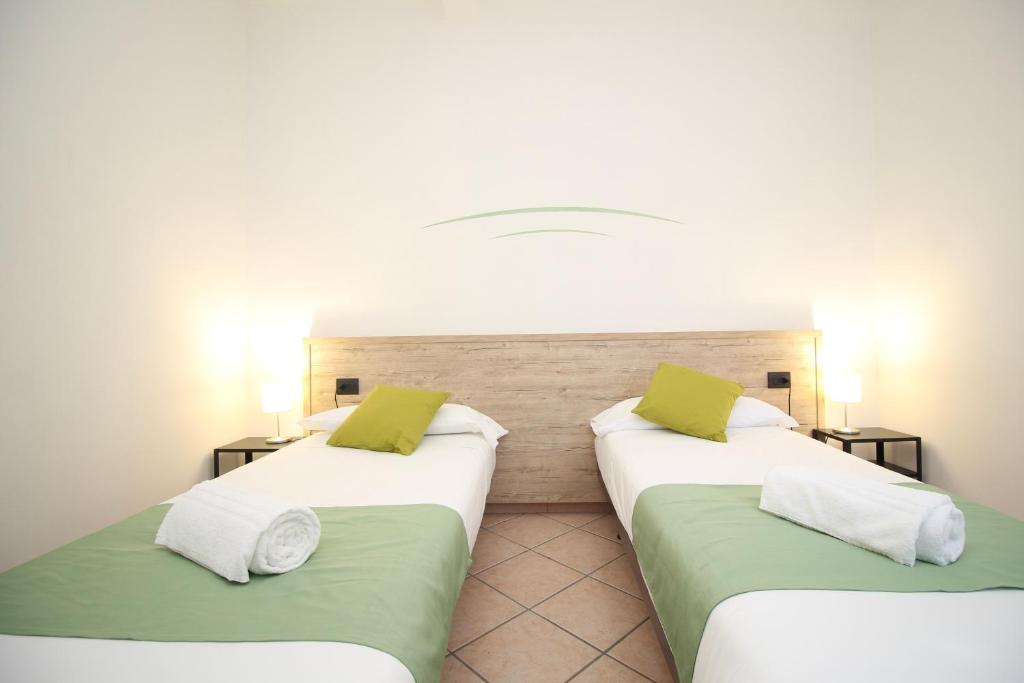Postel nebo postele na pokoji v ubytování Hotel Tornielli 9 by LVG Hotel Collection