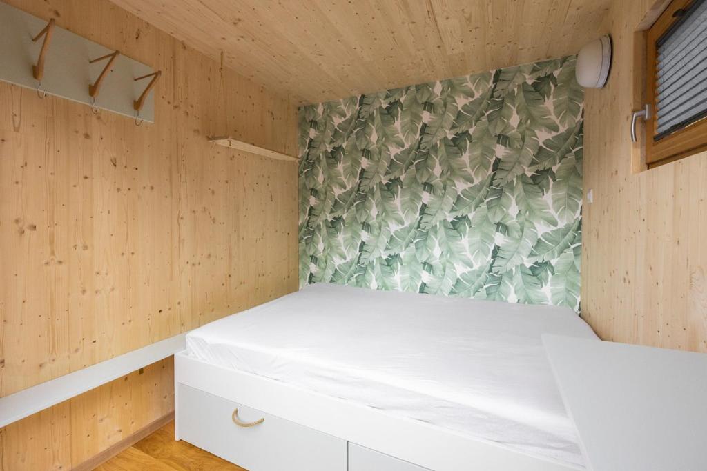 a bedroom in a tiny house with a bed at CHECKIN THE BOX Schloss Neubruck in Scheibbs