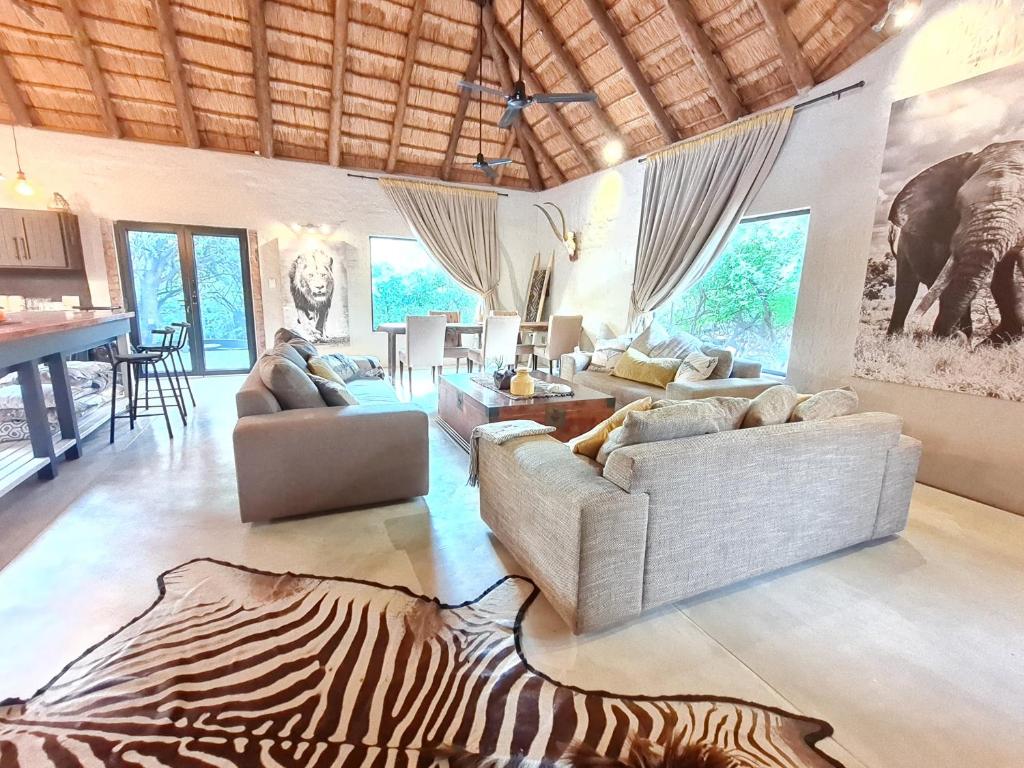 a living room with a zebra rug on the floor at Honey Badger Safari House in Marloth Park