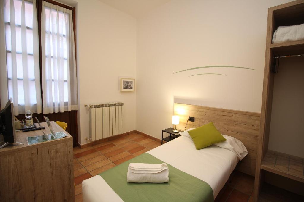 Postel nebo postele na pokoji v ubytování Hotel Tornielli 9 by LVG Hotel Collection