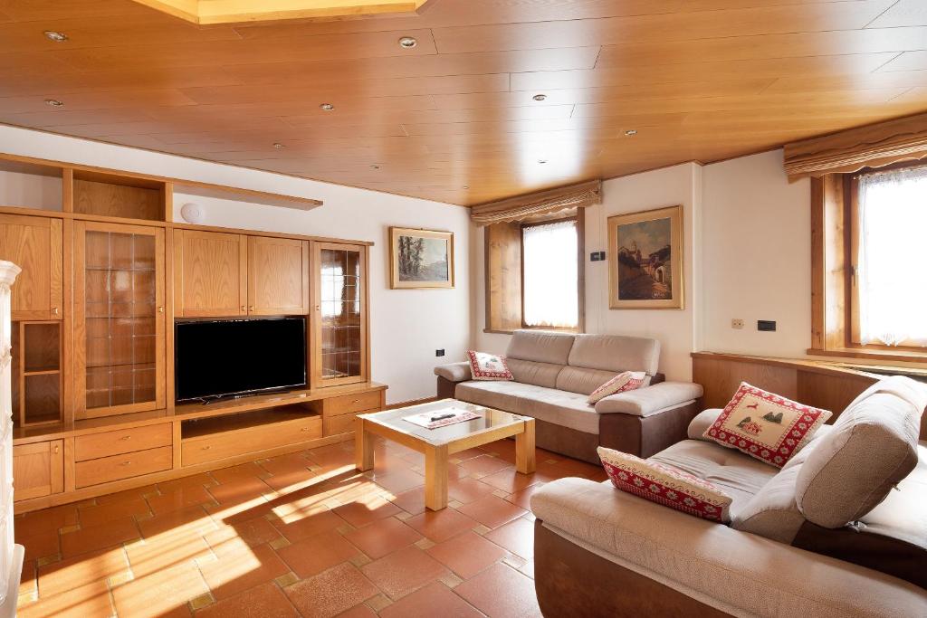 a living room with a couch and a tv at Chalet Gaste Big Family in Livigno