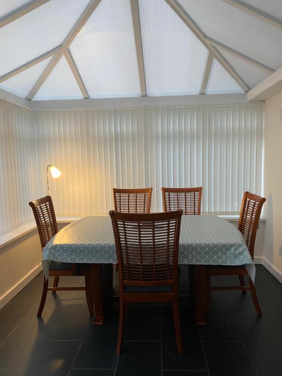 a dining room with a table and four chairs at Craster Crew House in Craster