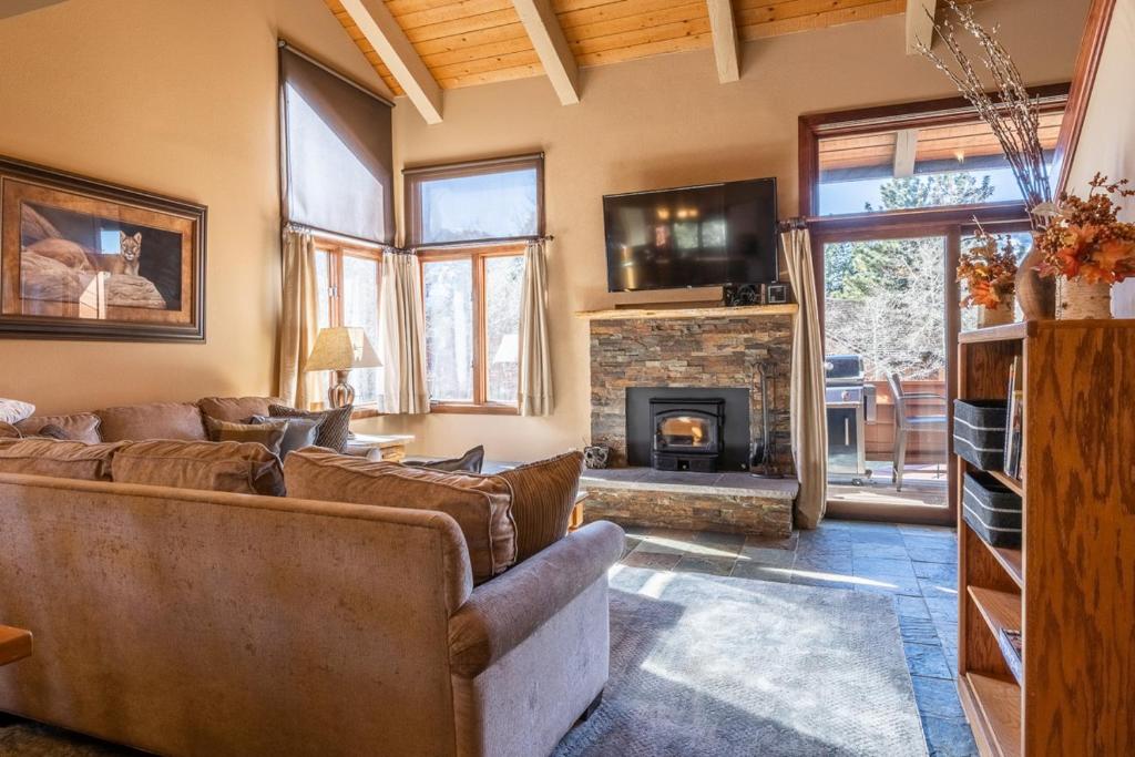 a living room with a couch and a fireplace at Sunrise 9 in Mammoth Lakes