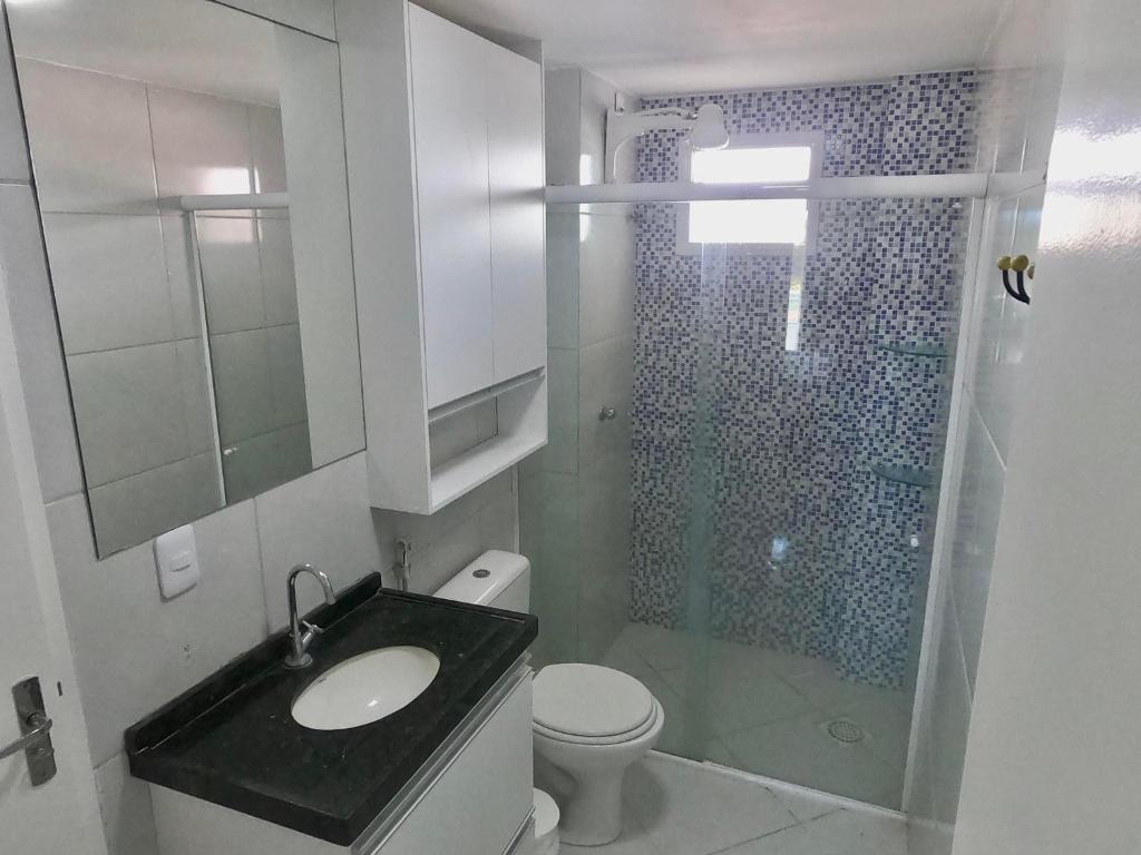 a bathroom with a toilet and a sink and a shower at Aloha Vibes Ap Cumbuco - Green Club in Cumbuco