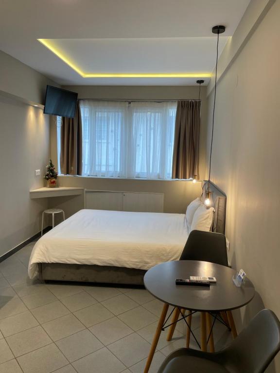 sypialnia z łóżkiem, stołem i biurkiem w obiekcie Ladadika Luxury Studios w Salonikach