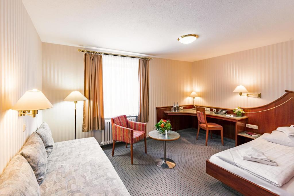 Postel nebo postele na pokoji v ubytování Hotel Wartburg