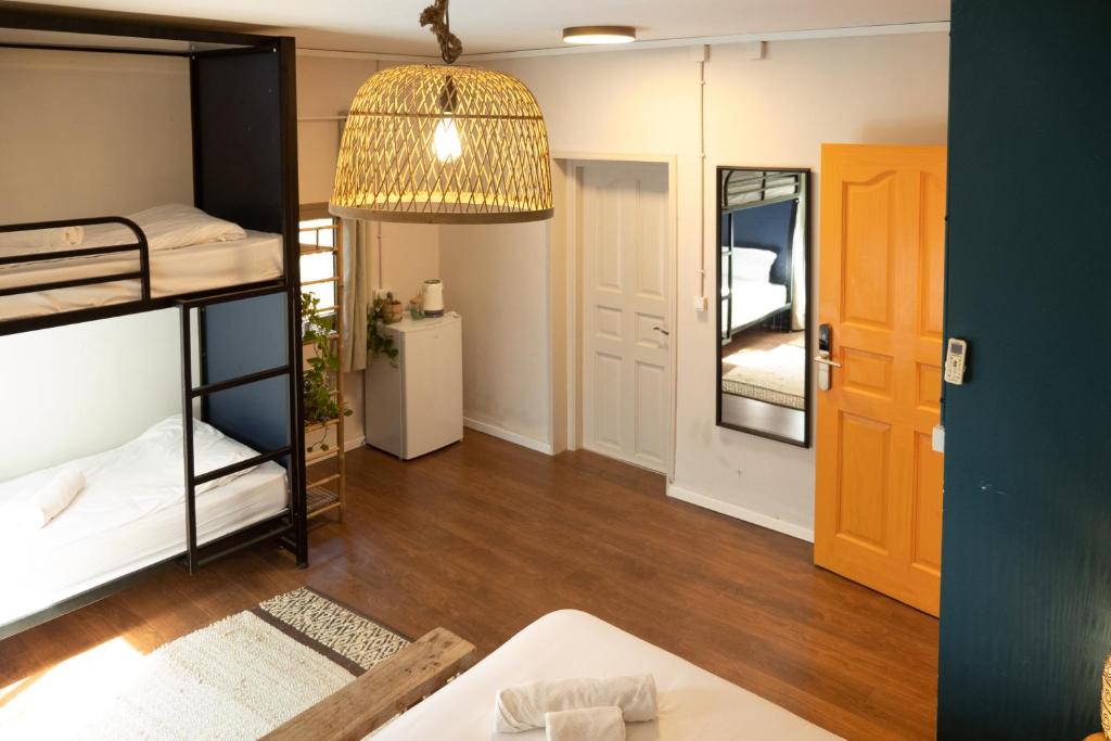 a dorm room with bunk beds and a mirror at Beit Oren Hotel in Beit Oren