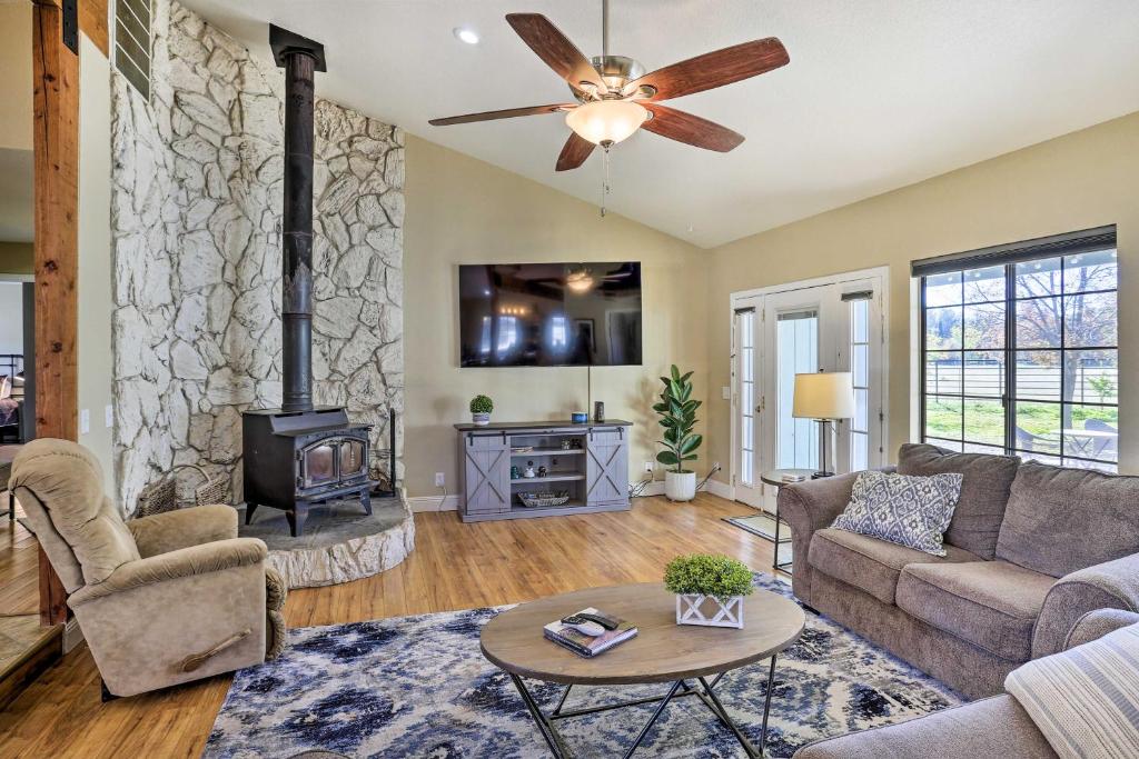 a living room with a couch and a fireplace at Updated Cottonwood Home with Patio and Fire Pit! in Cottonwood